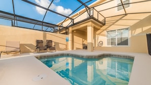 An indoor swimming pool with a glass ceiling, lounge chairs, and a view of the sky. - Luxury 4 Bedroom Townhome on Paradise Palms Resort, Orlando Townhome 3237 (Kissimmee)