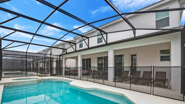 A modern house with a large pool, covered patio, and a clear sky. - Beautiful Mansion With Private Pool, Close to Disney, Orlando Mansion 2659 (Kissimmee)