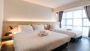 A hotel room with two beds, a nightstand with a lamp, and a large window with curtains. - BOOK Design Hotel (Chiang Mai)