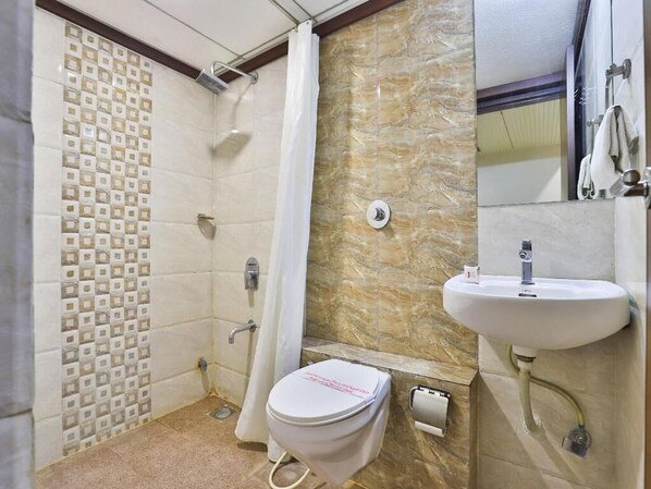 A bathroom with a shower, toilet, and sink.