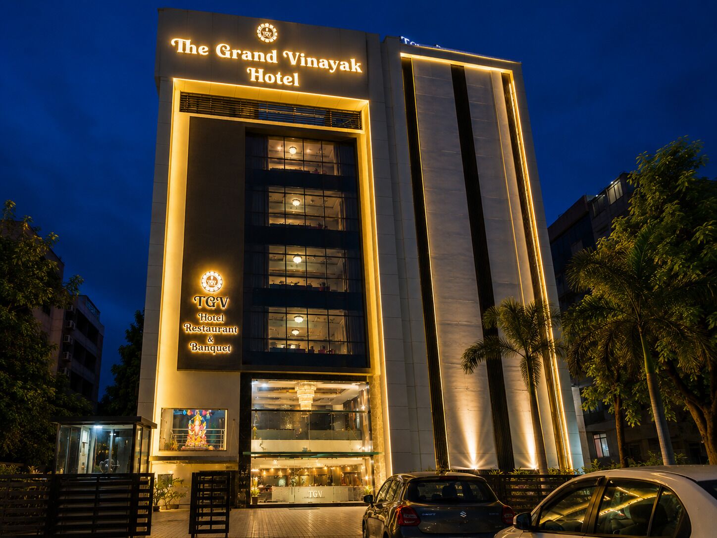 The Grand Vinayak Hotel with a prominent sign, multiple floors, and a modern facade.