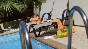 A poolside area with lounge chairs and a pool. - Beautiful Villa With Private Pool, Protaras Villa 1020 (Paralimni)