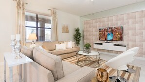 Un salon moderne avec un canapé, une table basse, un téléviseur et des objets décoratifs.