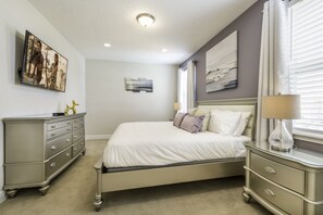 A bedroom with a bed, dresser, and artwork on the walls. - Villa in Encore Resort at Reunion 3443 (Kissimmee)