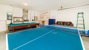 A room with a pool table, a billiards table, a brown leather couch, and a ladder against the wall. - Villa Close to Disney, Orlando Villa 3250 (Kissimmee)