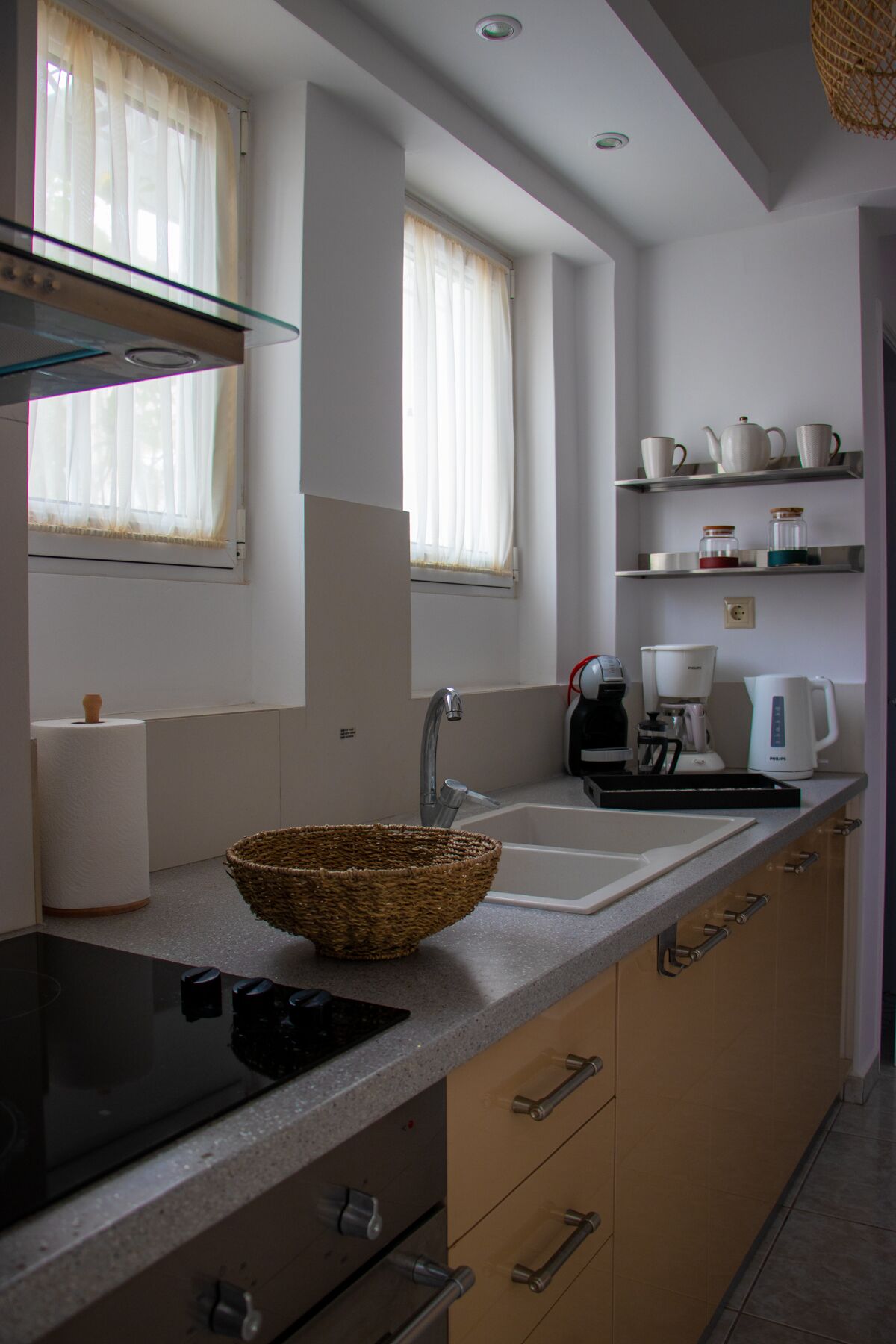 A modern kitchen with a large island, stainless steel appliances, and a coffee maker.
