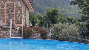 A swimming pool with a stone building in the background. - Villa With Pool in Recco Cinque Terr (Recco)