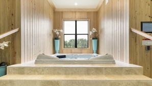 A spa area with a hot tub, steps leading up to it, and two potted plants. - Beautiful Mansion With Private Pool, Close to Disney, Orlando Mansion 1574 (Kissimmee)