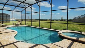 A swimming pool with a glass enclosure, surrounded by a brick patio and a grassy area. - Villa Close to Disney, Orlando Villa 3261 (Kissimmee)