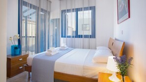 A hotel room with a bed, a nightstand, a lamp, and a window with curtains. - Beautiful Villa With Private Pool, Pernera Villa 1004 (Paralimni)