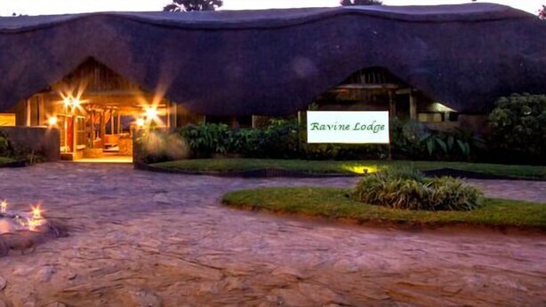 A thatched-roof building with a sign reading "Ravine Lodge". - Ravine Lodge (Livingstone)