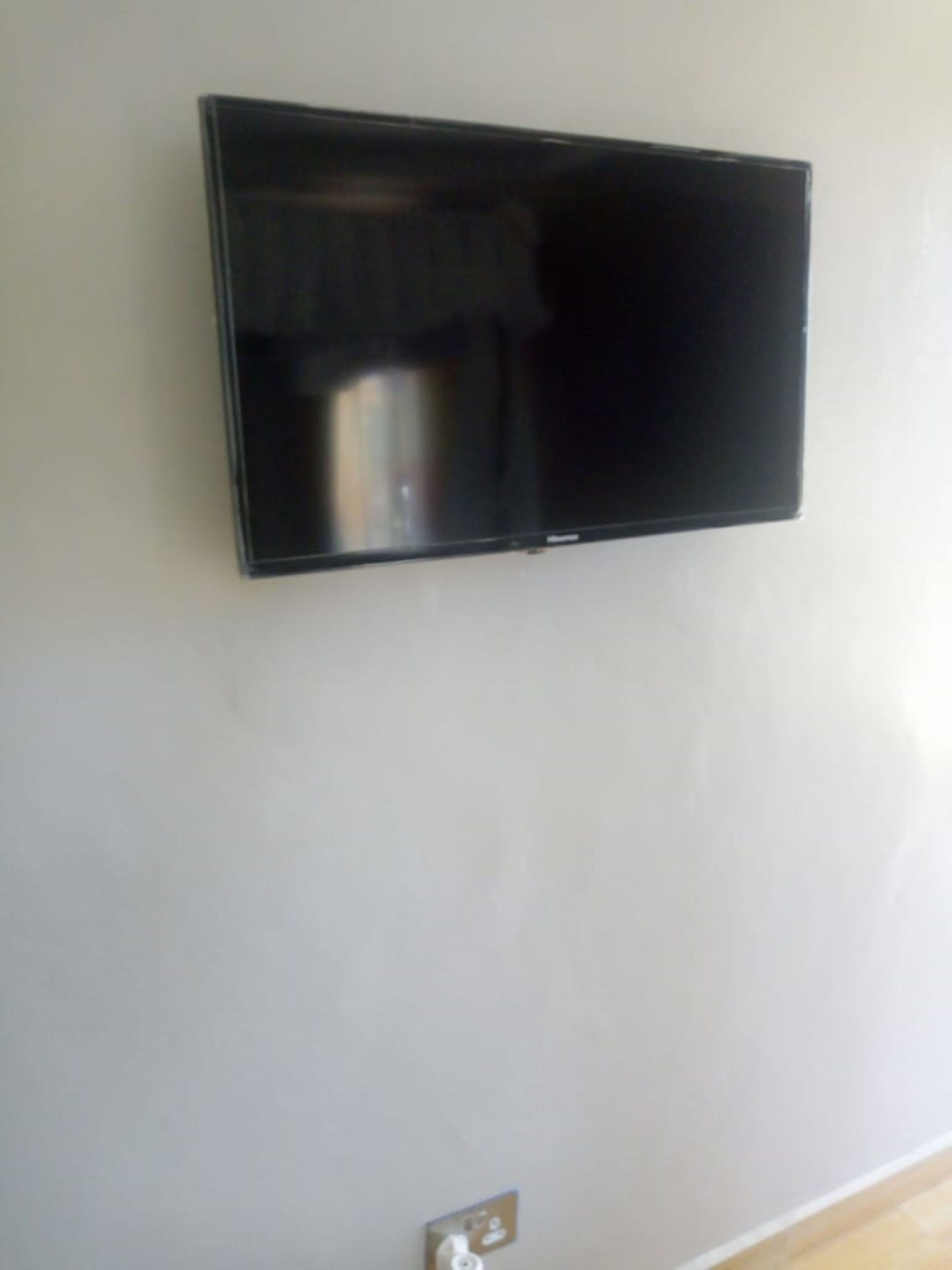 A flat-screen TV mounted on a plain wall.