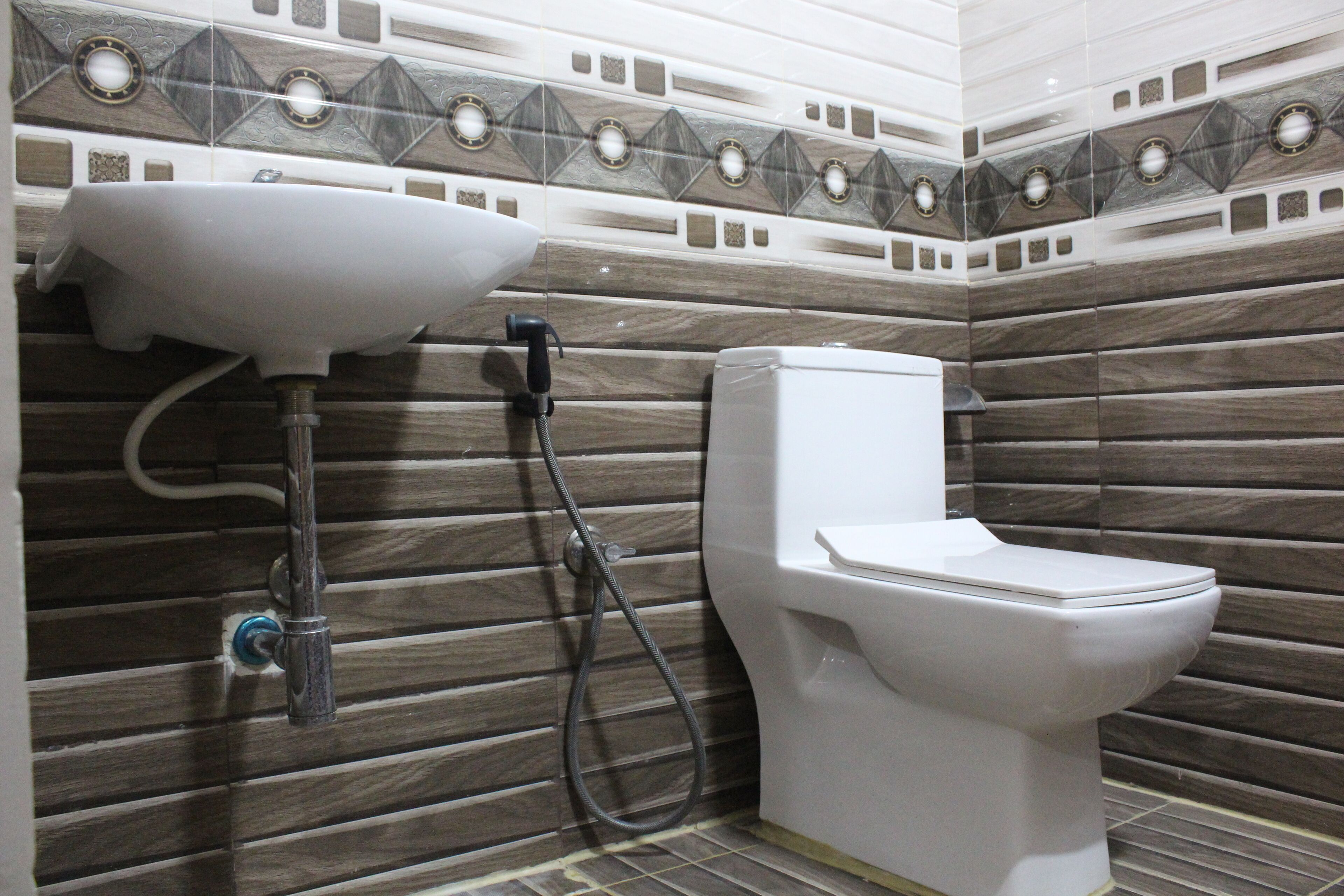 A bathroom with a sink, toilet, and shower.