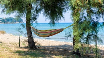 On the beach, white sand, sun-loungers, beach umbrellas
