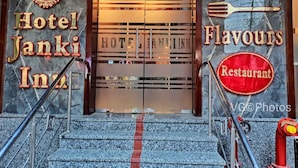 A hotel entrance with steps leading up to a glass door. The hotel name 'Hotel Janki Inn' is displayed on the left, and 'Bananasi Flavours Restaurant' is on the right. - Hotel Janki Inn Varanasi (Varanasi)