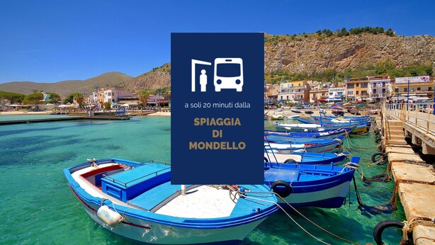 A coastal scene with boats docked at a pier, a clear blue sky, and a mountainous backdrop. - Tukory - Flat For Rent - City Center Palermo (Palermo)