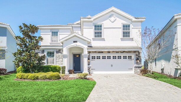 A two-story house with a garage, a front door, and a driveway.