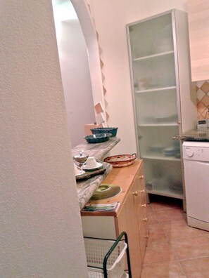 Kitchen features an oven, dishwasher, and marble countertop.
