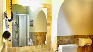 A bathroom with a sink, mirror, towel rack, shower, and toilet. - Dependance Naples City Centre (Naples)