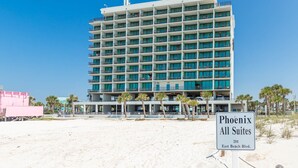 Un hotel de varios pisos con balcones, situado en la playa.