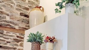 A wall-mounted wooden shelf with decorative items and a potted plant. - A peaceful escape in rural Herefordshire - perfect for families and friends. (Nr. Hereford)