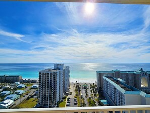 A high-rise hotel with a view of the beach and ocean.