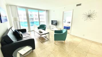 Suíte família, 2 quartos, sacada, vista parcial para o mar | Área de estar | TV LCD 40 polegadas com canais a cabo, TV