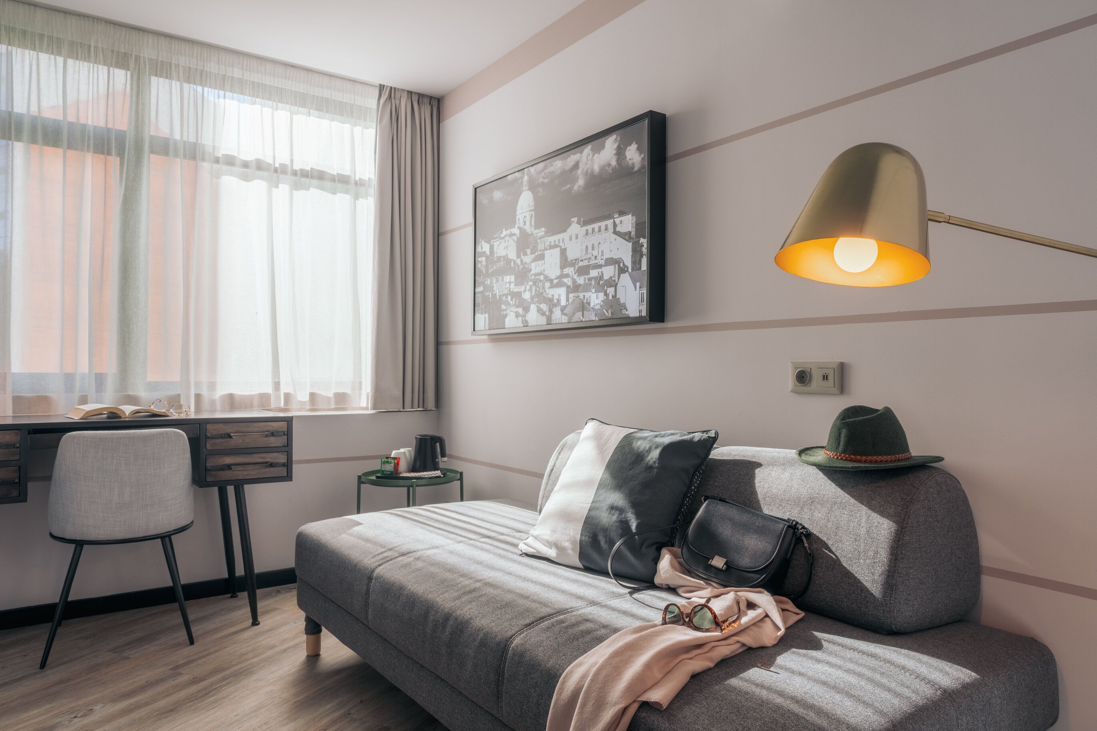 A modern bedroom with a bed, a desk, and a chair.
