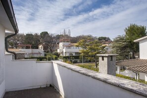 A residential area with white buildings, a stone wall, and a clear sky. - M104 - Marcelli, villa with garden 200 meters from the sea (Marcelli)