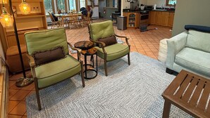A spacious living area with a high ceiling, a ceiling fan, and a large window. - Lynch Mountain Retreat (Cooperstown)