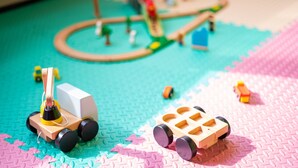 A toy train set on a colorful play mat. - Holiday Inn Express Hangzhou Westlake East by IHG (Hangzhou)