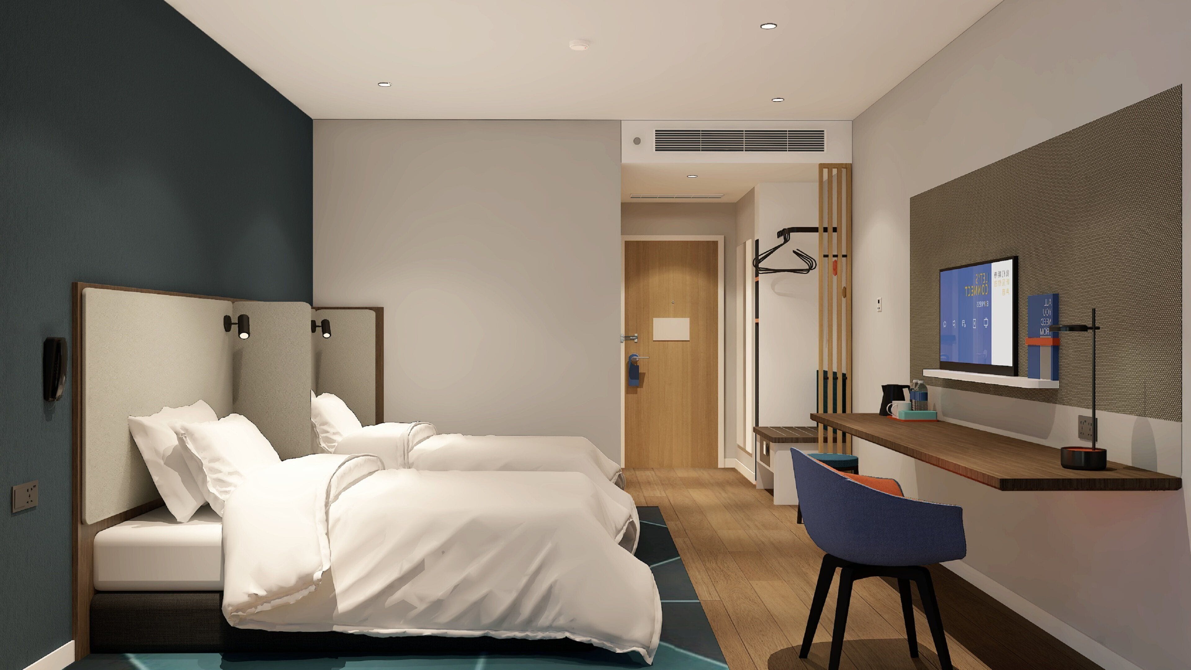A modern hotel room with a bed, a desk, a chair, a TV, and a mirror.