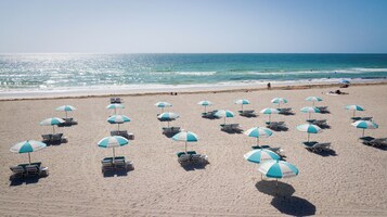 Beach nearby, white sand, sun loungers, beach towels