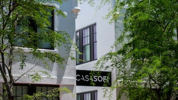 A modern building with a sign reading "CASA SOFI" and the number "735" on the facade.