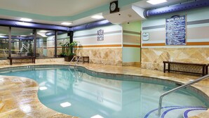 An indoor swimming pool with clear water, a clock on the wall, and a pool rules sign. - Ocean Front resort next to Myrtle Beach Sky Wheel! (Myrtle Beach)
