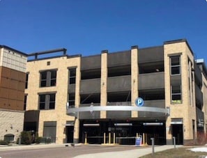 Park in style with our secure, multi-story parking garage featuring vertical columns and a flat roof.