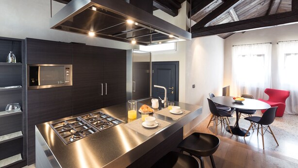 A modern kitchen with a central island, built-in microwave, and stainless steel appliances. - Elegant Modern Design Home. Campo dei Mori. Air Conditioning. Wifi. (Venezia)
