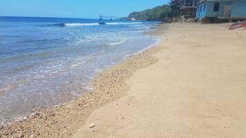 Ein Strand mit Kieselsteinen und blauem Himmel.