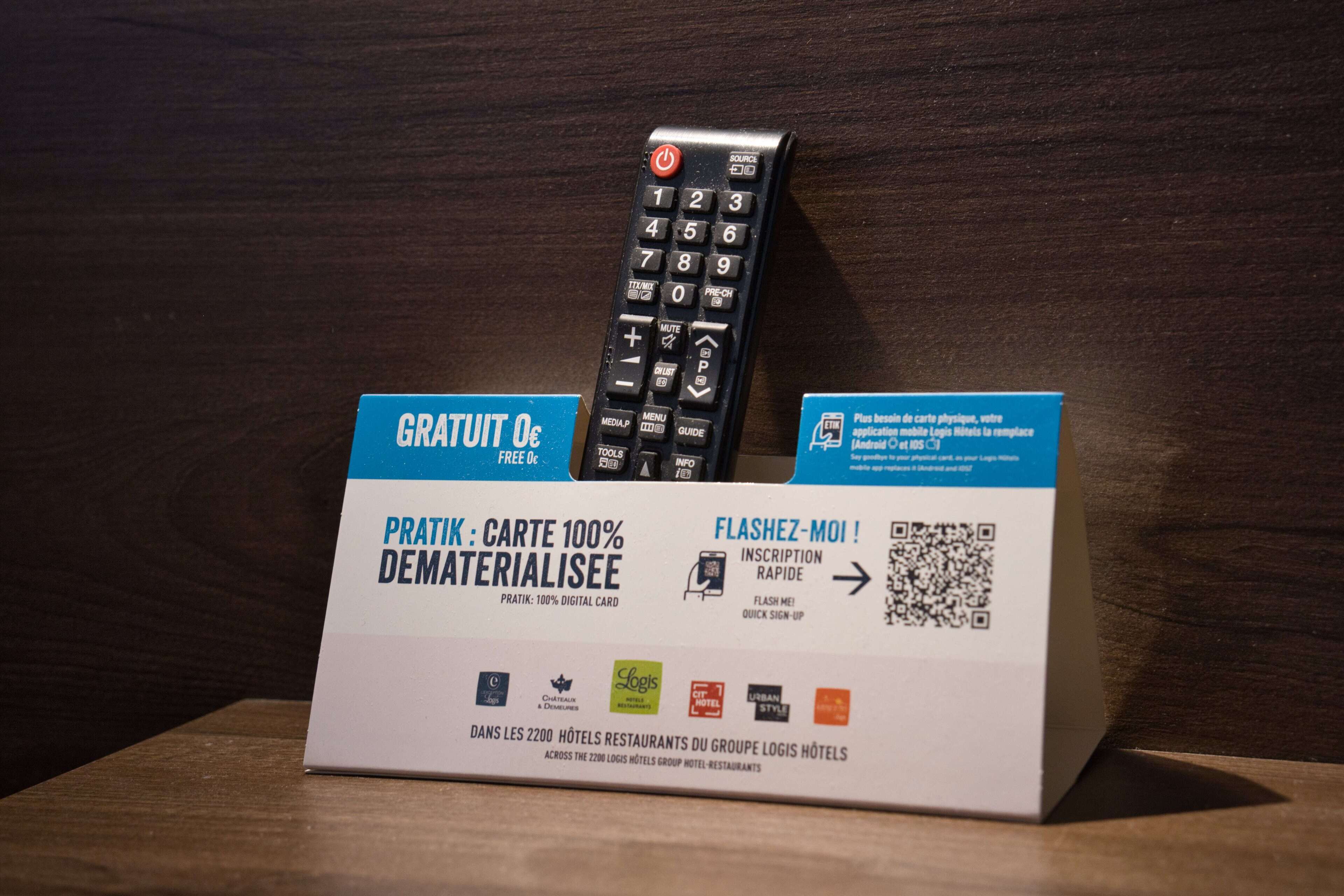 A sign with a digital card offer and a remote control.