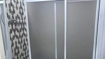 Shower, hair dryer, slippers, towels
