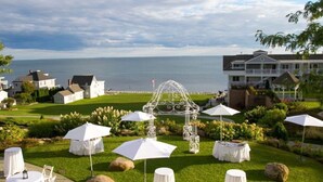 A coastal hotel with outdoor seating and a gazebo.