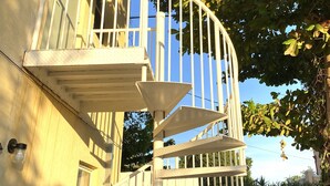 A spiral staircase with white railings leading to a balcony. - Two Bedroom Apartment, Pool -2 Min  Walk to Miami Design District (Miami)