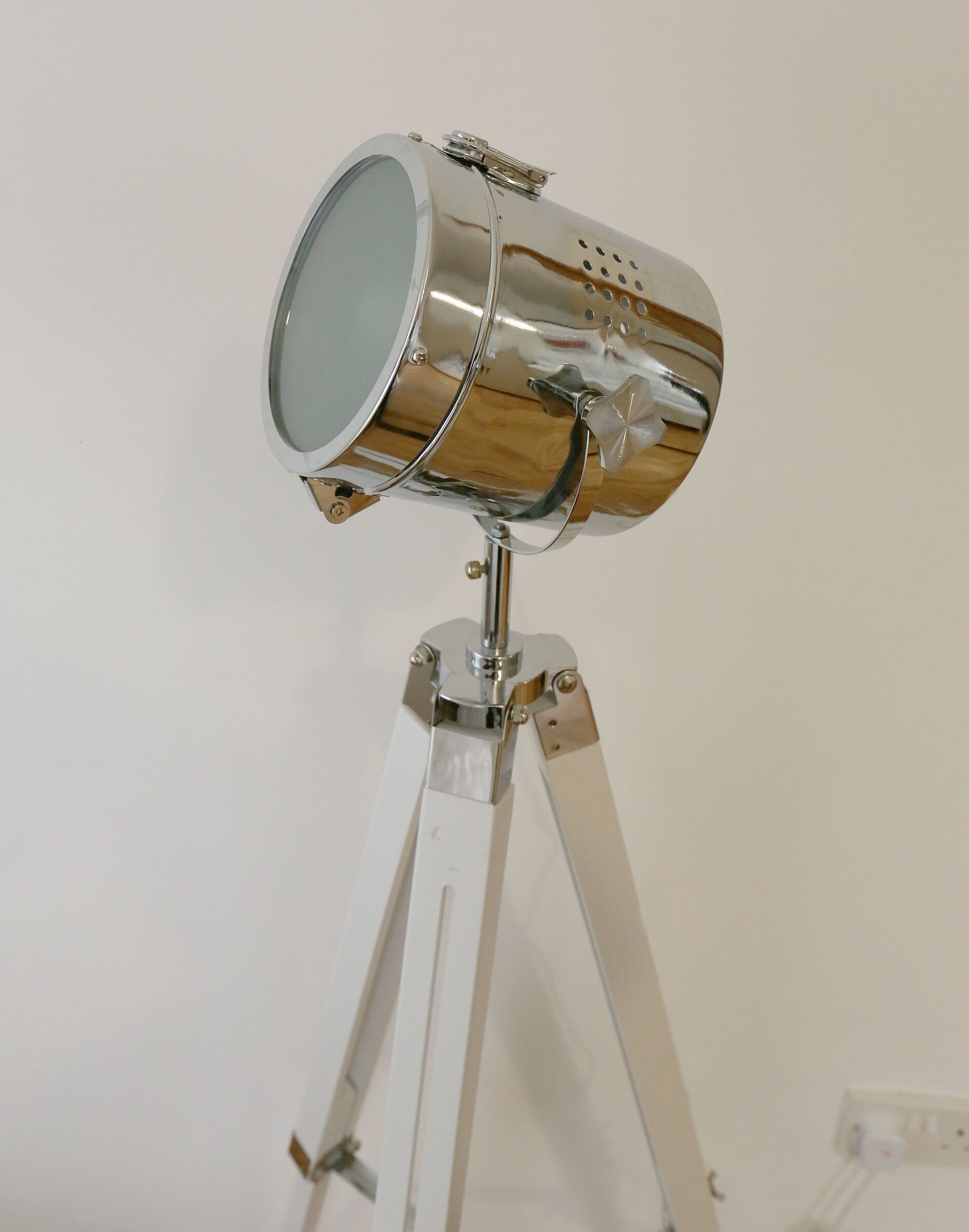 A telescope with a metallic finish mounted on a tripod.