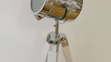 A telescope with a metallic finish mounted on a tripod.