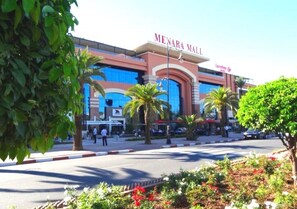 A large shopping mall with a prominent sign reading "MENARA MALL".