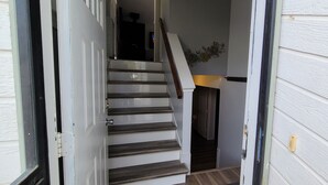 A staircase leading to a second floor with a wooden handrail and a door at the top. -  Entire Townhouse 1 Car Garage +Jacuzzi (West Wendover)