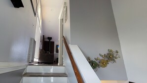 A staircase with a handrail, a radiator, and a wall-mounted decoration. -  Entire Townhouse 1 Car Garage +Jacuzzi (West Wendover)