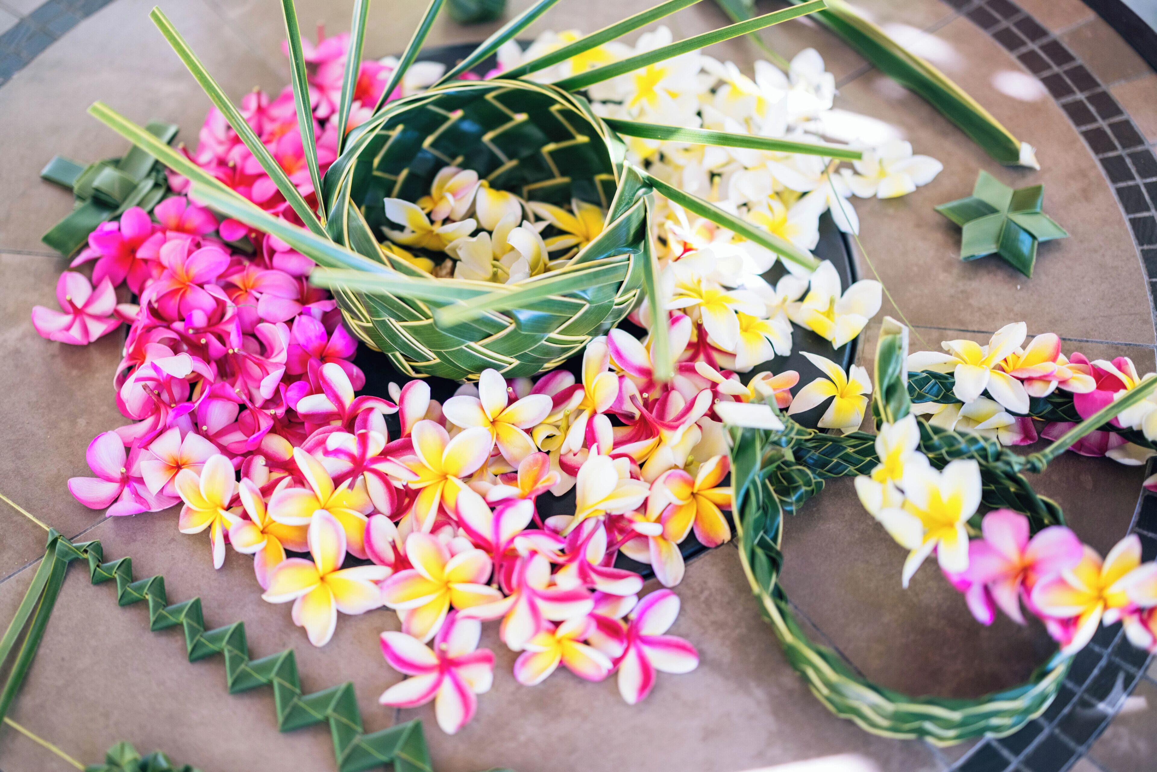 A woven basket filled with flowers and leaves.