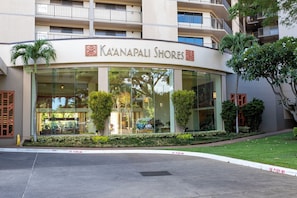 A hotel named Ka'anapali Shores with a modern facade, large windows, and a well-maintained lawn.