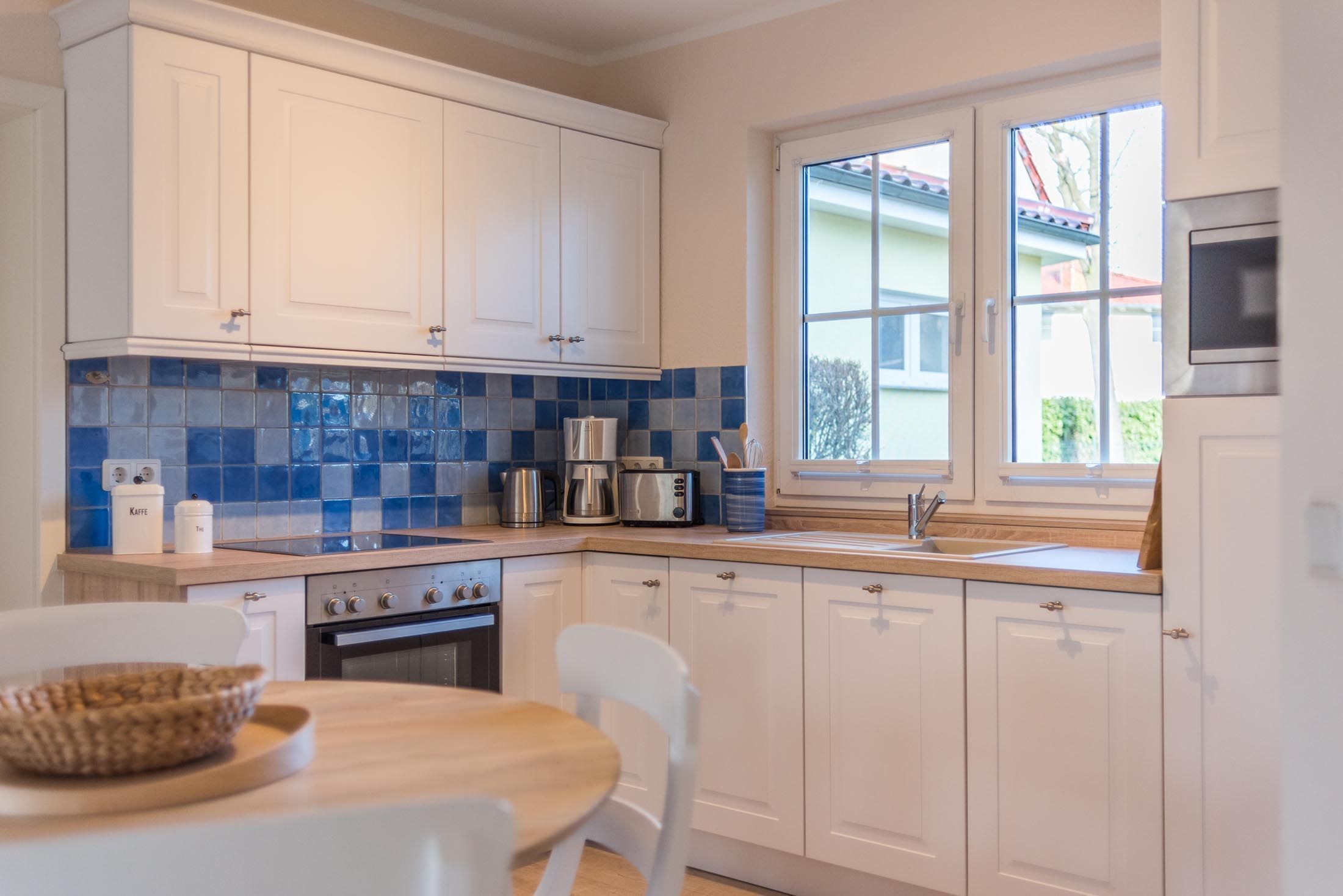 Fridge, stovetop, dishwasher, coffee/tea maker